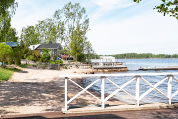 Sandy beach on the Baltic Sea in Finland. Summer houses and a pier in the city of Kotka.