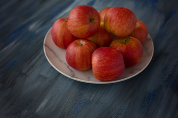 Red ripe apples on a plate