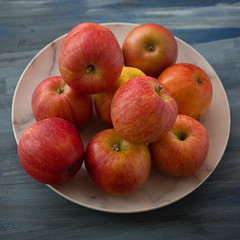 Red ripe apples on a plate