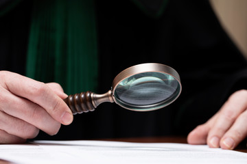 Lawer holding magnifying glass. Criminal case investigation