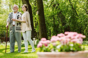 Fototapeta premium Garden of the nursing home and nurse with patient