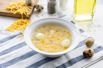 Chicken broth with quail egg and noodles
