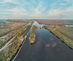 Sluice on the Moscow river near city Dzerzhinsky, aerial drone view on spring