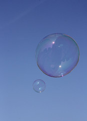 Soap Bubbles floating in blue sky