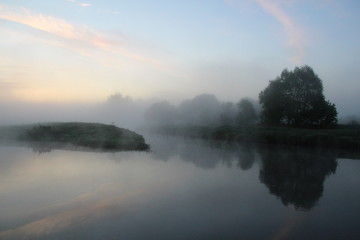 Fototapeta na wymiar Misty beautiful summer morning on the calm river