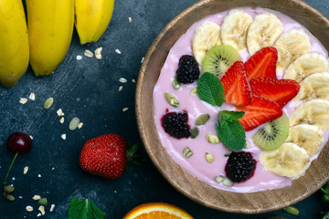 Fototapeta na wymiar Yogurt smoothie bowl. Vegetarian healthy food (berries, yogurt, muesli, fruit)