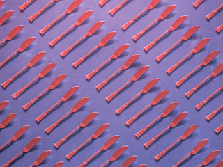 Red spread knives pattern on purple background