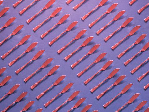 Red spread knives pattern on purple background