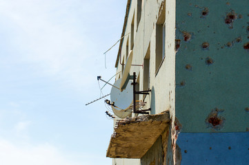 satellite dishes on the damaged building from the fighting