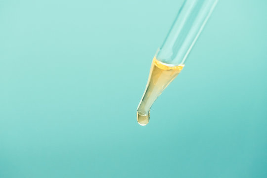 Glass Pipette With Cosmetic Oil Essence Close Up