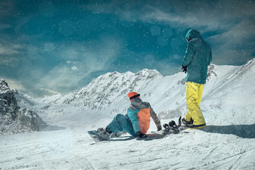 Men and Woman on the snowboards before sport action at sunny day