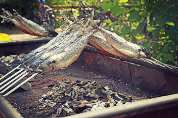 Mackerels grilled outside on the fire embers for a rustic party