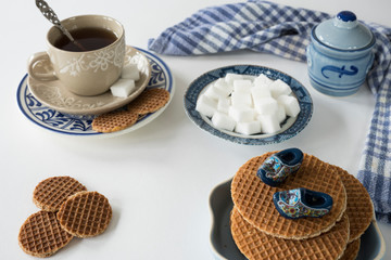 stroopwafel, typical syrup cookie from the Netherlands, with tea and Delfts blue clogs
