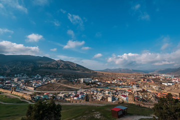 Panorama of mountains and small town Sudak in warm sunny day, beautiful nature travel landscape