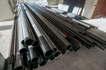 Group of new metal pipes or tubes on construction site