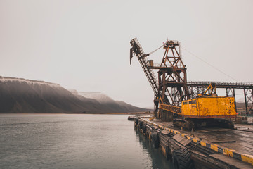 The sudden abandoned russian mining town Pyramiden. rusted harbor with old crane, Isfjorden, Longyearbyen, Svalbard, Norway.