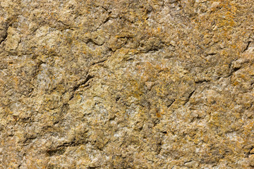 Background of granite. Texture of granite stone. Pattern of roughened surface. Texture of brown stone