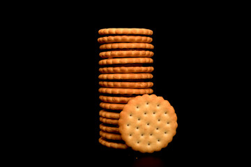 Chocolate Cookies isolated on black background. Tall stack of chocolate chip cookies on black. 