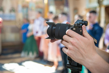 Videographer at work, filming ceremonial events in the church