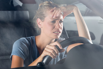 driver suffering migraine driving a car