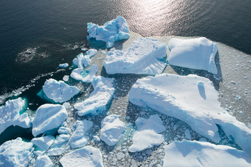 Aerial view of icebergs melting on the water, climate change and warming