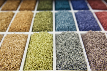 samples of multi-colored carpets on the shelves