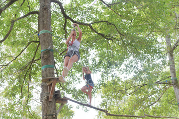 women climbing in adventure park