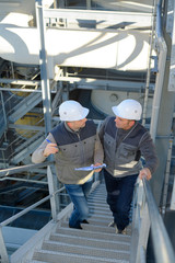 workers going up the stairs in a factory