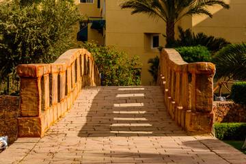 Old stone arch footbridge in a garden