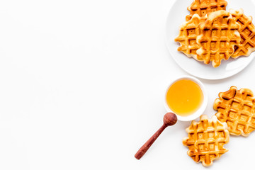 Traditional belgian waffles with honey on served wooden table background top view mockup