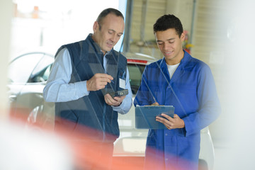 2 mechanic men try to fix and setup boat engine