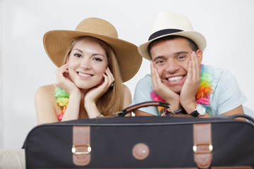happy couple with suitcases ready for vacation