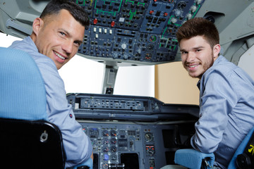 apprentice on flight simulator cockpit