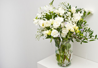 Fototapeta na wymiar White flowers on glass vase home decoration.