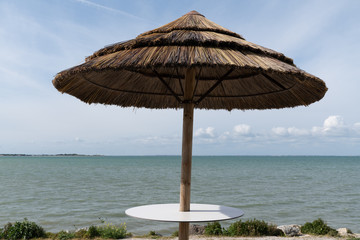 Straw umbrellas on the beach coast