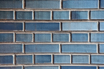 The wall is made of bricks. Brickwork in the construction of a new building. The use of a classic building material.