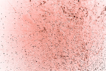 Vintage pink background. Rough painted wall of living coral color. Imperfect plane of beige colored. Uneven old decorative toned backdrop of beige tint. Texture of pink hue. Ornamental stony surface.