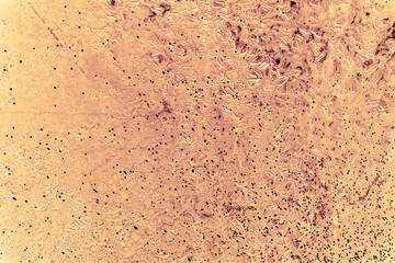 Vintage yellow background. Rough painted wall of aspen gold color. Imperfect plane of golden colored. Uneven old decorative toned backdrop of yellow tint. Texture of gold hue. Ornamental stony surface