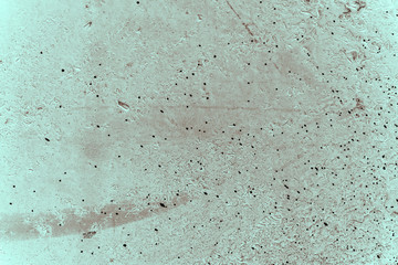 Vintage cyan background. Rough painted wall of hazel color. Imperfect plane of brown colored. Uneven old decorative toned backdrop of blue tint. Texture of azure hue. Ornamental stony surface.