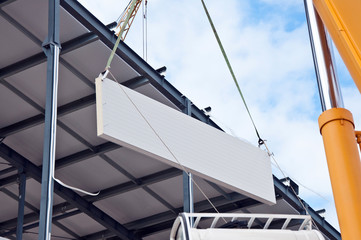 Installation of insulation panels on the construction of a new building. Warming of the building...