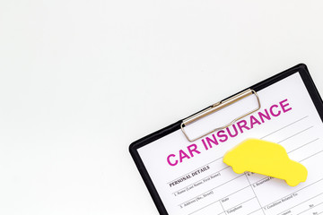 Car buying and insurance concept with car figure and form on white background top view mock up