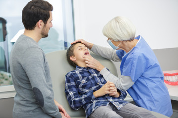 little boy opening mouth during examination