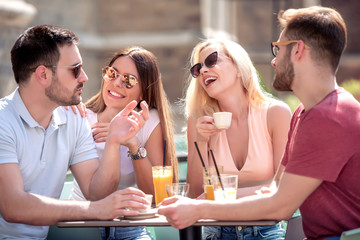 Group of friends having fun in cafe