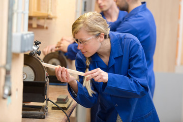 woman sanding a pieces of wood