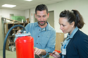 fire extinguisher salesman showcasing the product