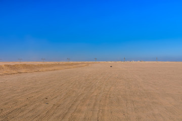 Fototapeta na wymiar High voltage power line in arabian desert not far from the Hurghada city, Egypt