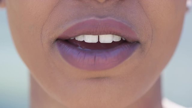 Close up of young black female mouth talking to camera