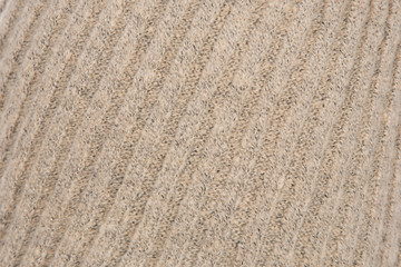 background of knitted wool threads, knitting on the cap, headdress close-up