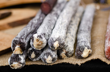 Assorted meat products including ham and sausages.