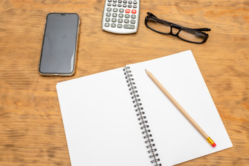 Top view of wooden desktop with office tools. Mock up, soft focus.
